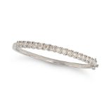 A DIAMOND BANGLE in 9ct white gold, the hinged bangle set with a row of round brilliant cut diamo...