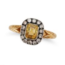 A YELLOW SAPPHIRE AND DIAMOND CLUSTER RING in yellow gold and silver, set with an octagonal step ...