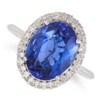 A TANZANITE AND DIAMOND CLUSTER RING in 18ct white gold, set with an oval cut tanzanite of 4.08 c...