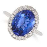A TANZANITE AND DIAMOND CLUSTER RING in 18ct white gold, set with an oval cut tanzanite of 4.08 c...