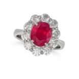 A BURMESE RUBY AND DIAMOND CLUSTER RING in platinum, set with an oval cut ruby of 3.41 carats in ...