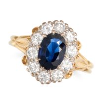 A SAPPHIRE AND DIAMOND CLUSTER RING in 18ct yellow gold, set with an oval cut sapphire of approxi...