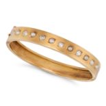 AN ANTIQUE DIAMOND AND PEARL BANGLE in yellow gold, the hinged bangle set with a row of alternati...