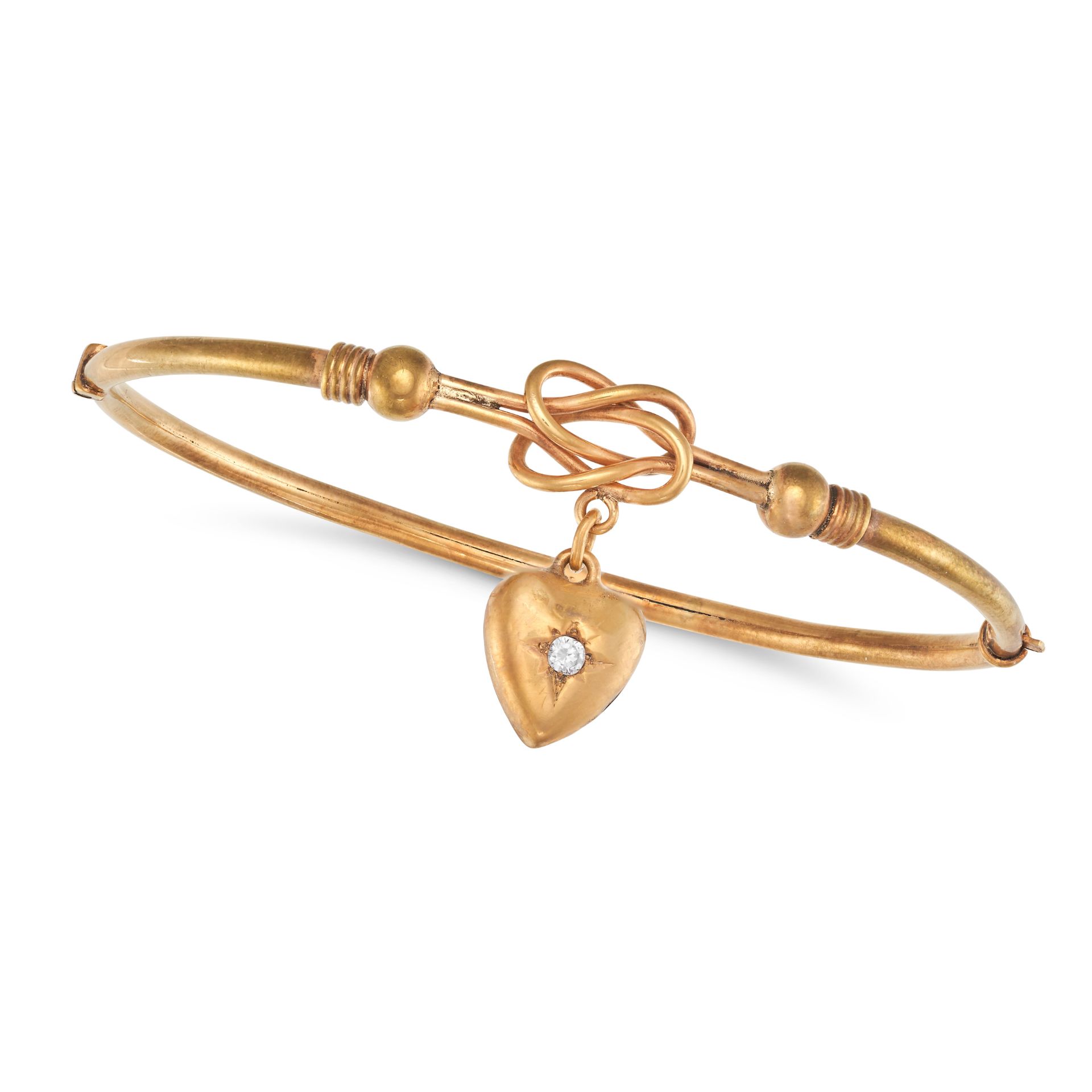 AN ANTIQUE DIAMOND LOVERS KNOT BANGLE in 9ct yellow gold, the hinged bangle comprising a lover's ...