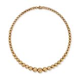 A GOLD BEAD NECKLACE in 9ct yellow gold, comprising a single row of graduating gold beads, London...