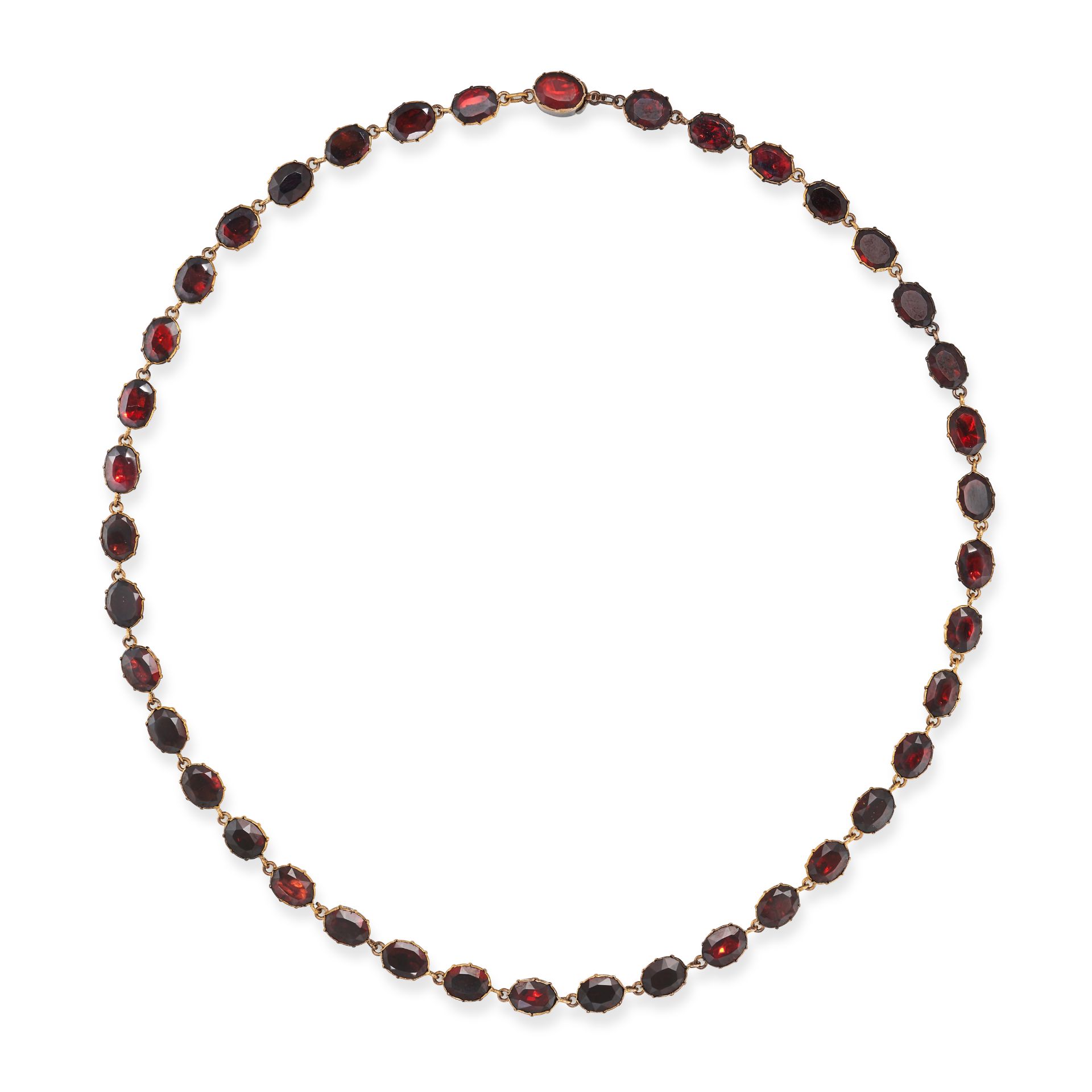 AN ANTIQUE GARNET RIVIERE NECKLACE comprising a row of foil back garnets, no assay marks, 40.5cm,...