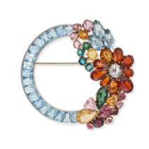 A GEMSET BROOCH in 14ct white and yellow gold, the circular brooch set with a row of calibre cut ...