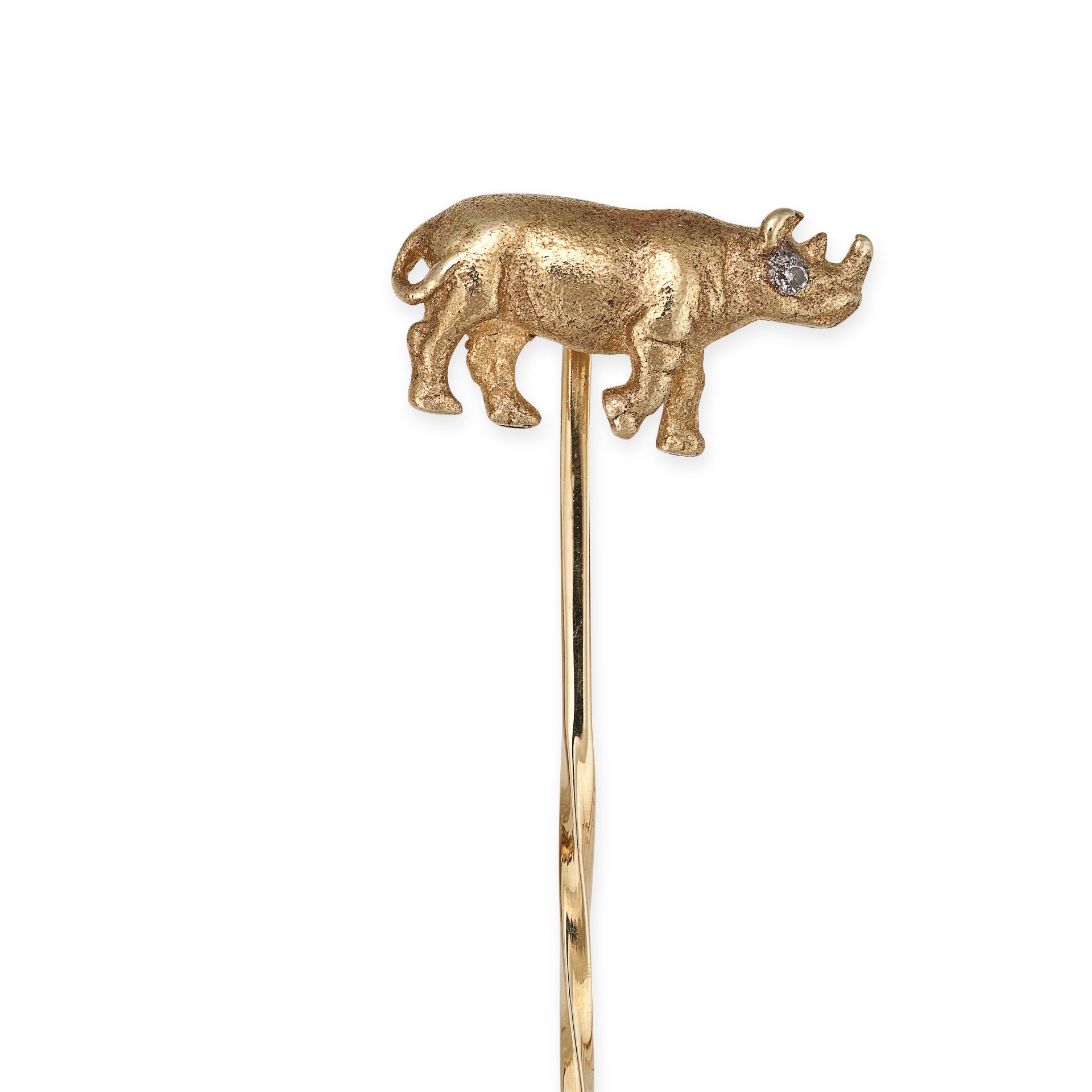 A DIAMOND RHINOCEROS STICK / TIE PIN in yellow gold, designed as a rhinoceros, the eye set with a...