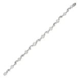 A DIAMOND BRACELET in white gold, set with old cut diamonds alternating with scrolling links, the...
