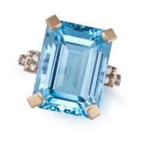A BLUE TOPAZ AND DIAMOND RING in 9ct yellow gold, set with an octagonal step cut blue topaz, the ...