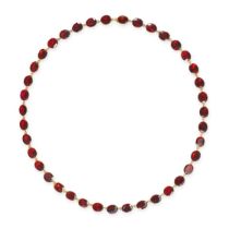 A GARNET RIVIERE NECKLACE in 9ct yellow gold, comprising a row of cushion cut garnets, stamped 9K...