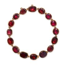 AN ANTIQUE GARNET BRACELET in yellow gold, comprising a row of cushion cut garnets, no assay mark...