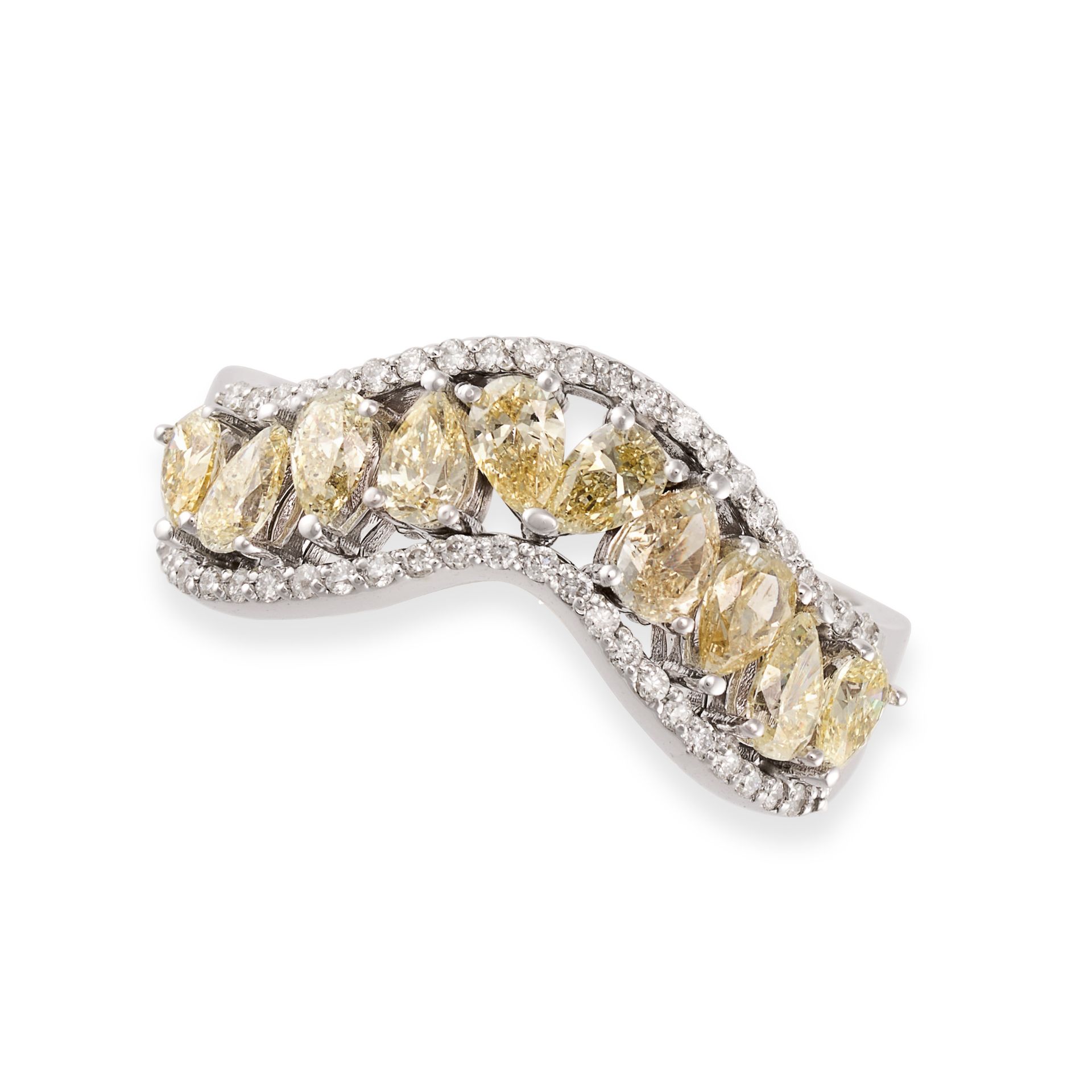 A DIAMOND DRESS RING in 14ct white gold, set with a row of pear cut yellow diamonds accented by r...