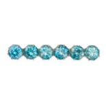 A BLUE ZIRCON BAR BROOCH in yellow gold and silver, comprising a row of round cut blue zircon, th...