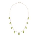 A PERIDOT FRINGE NECKLACE in 18ct yellow gold, comprising a trace chain suspending nine fancy cut...