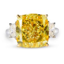 AN IMPORTANT FANCY VIVID YELLOW DIAMOND RING in platinum and 18ct yellow gold, set with a cushion...