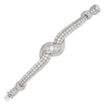 A DIAMOND BRACELET in white gold and platinum, the scrolling strap bracelet set throughout with r...