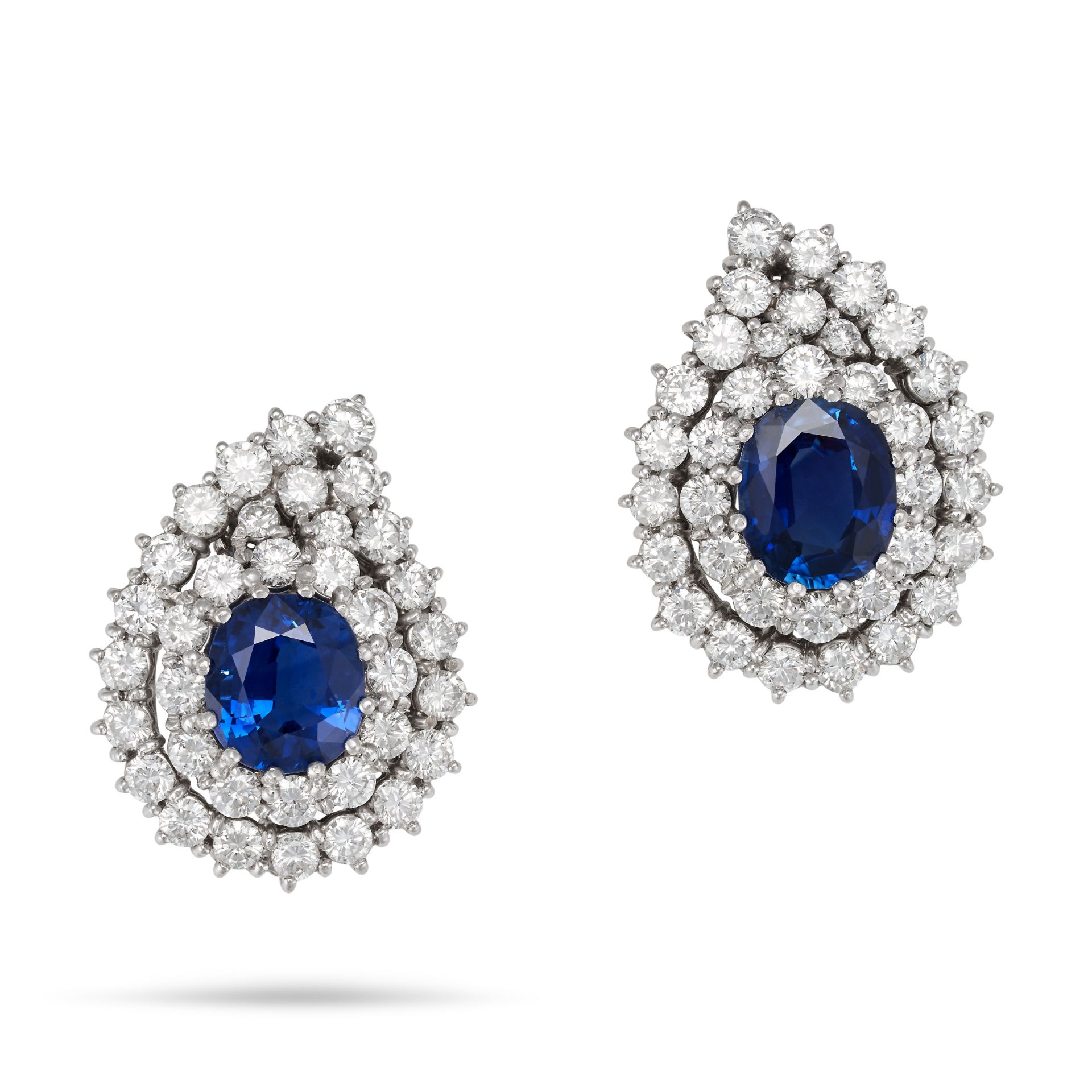 A PAIR OF SAPPHIRE AND DIAMOND CLIP EARRINGS in 18ct white gold, each set with a cushion cut sapp...