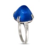 A FINE SAPPHIRE AND DIAMOND RING in platinum, set with a sugarloaf cabochon sapphire of approxima...