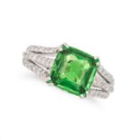 A TSAVORITE GARNET AND DIAMOND RING in 18ct white gold, set with a cushion cut tsavorite garnet o...