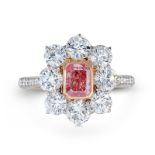 AN IMPORTANT NATURAL FANCY VIVID PINK DIAMOND AND DIAMOND CLUSTER RING in platinum and 18ct rose ...