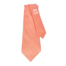 HERMES, A VINTAGE CORAL TIE Condition grade B. 147cm x 8cm. 100% silk coral toned tie.