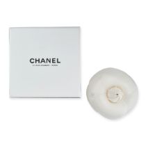 CHANEL, A CAMELLIA FLOWER BROOCH, composed of ivory toned fabric in the shape of petals, with a '...