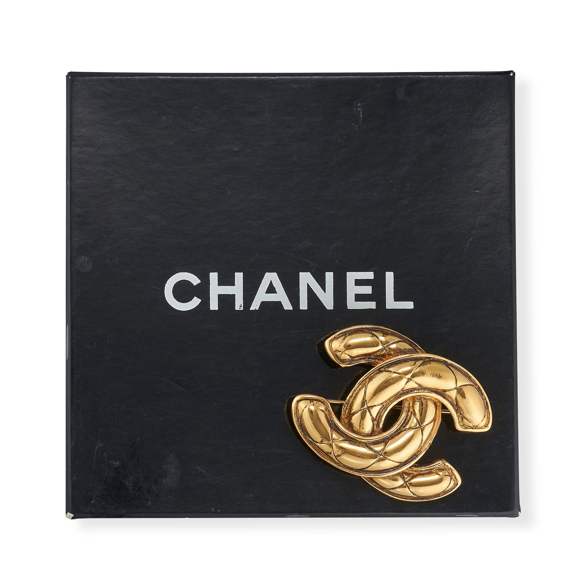 CHANEL, A VINTAGE CC BROOCH plated in 24ct gold, designed as a quilted interlocking 'CC' logo, si... - Image 2 of 2