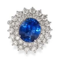 A SAPPHIRE AND DIAMOND CLUSTER RING in 18ct white gold, set with an oval cut sapphire of 3.74 car...