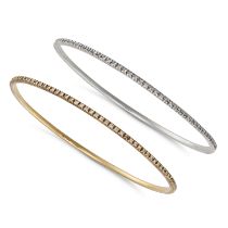 A PAIR OF DIAMOND BANGLES in 14ct yellow and white gold, each set all around with a row of round ...