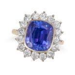BOODLES, A TANZANITE AND DIAMOND CLUSTER RING in 18ct yellow gold, set with a cushion cut tanzani...