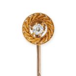 AN ANTIQUE DIAMOND STICK PIN in yellow gold, set with an old cut diamond in a twisted gold border...