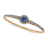 AN ANTIQUE SAPPHIRE AND DIAMOND BANGLE in yellow gold and silver, the hinged bangle set with a ro...