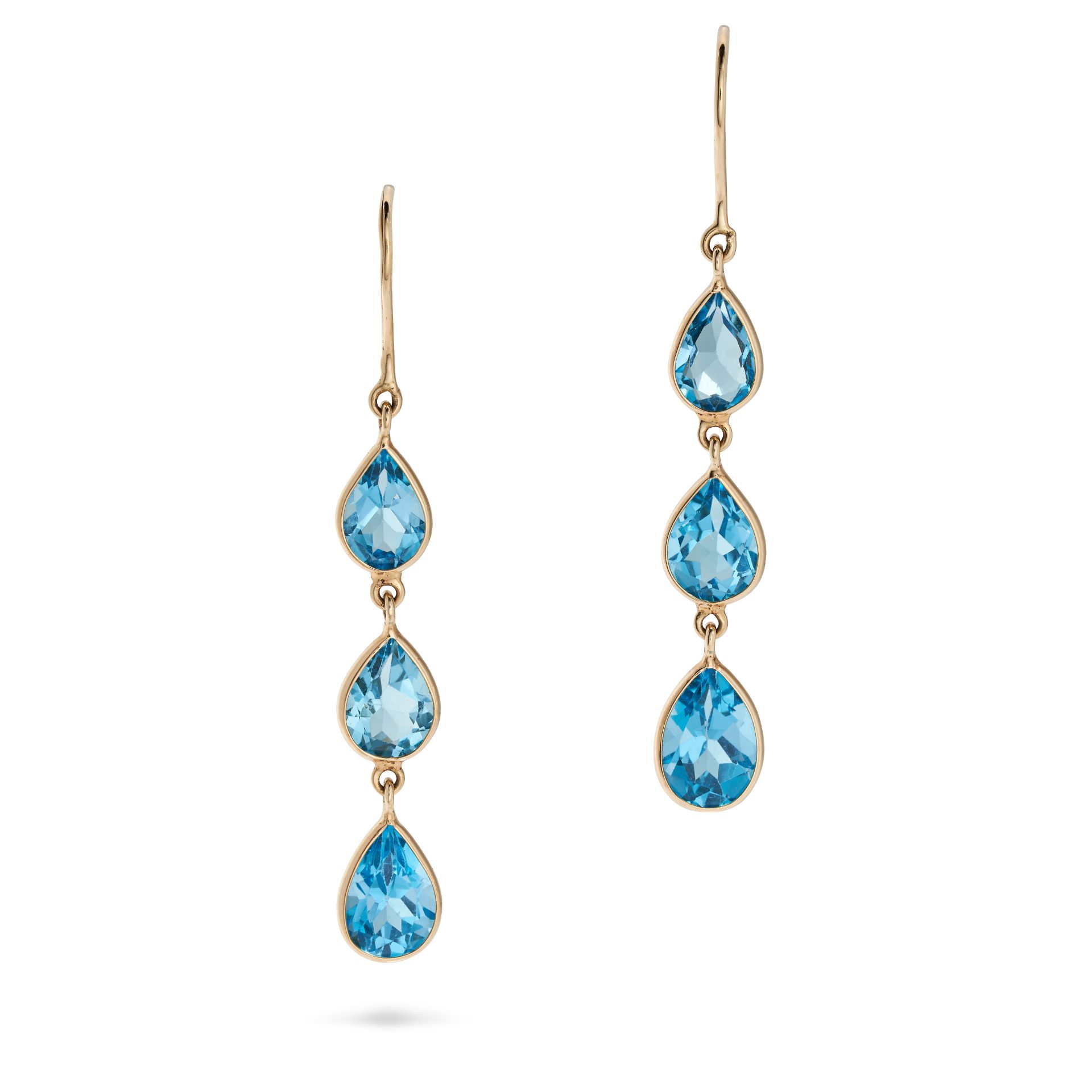 A PAIR OF BLUE TOPAZ DROP EARRINGS in 14ct yellow gold, each set with a row of three pear cut blu...