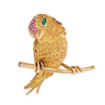 A FRENCH RUBY AND EMERALD BROOCH in 18ct yellow gold, designed as a bird perched on a brach, the ...