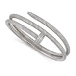 A DIAMOND NAIL BANGLE in 18ct white gold, designed as a curved nail pave set with round brilliant...