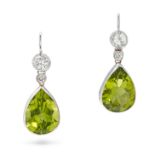 A PAIR OF PERIDOT AND DIAMOND DROP EARRINGS in white gold, comprising a row of round brilliant cu...