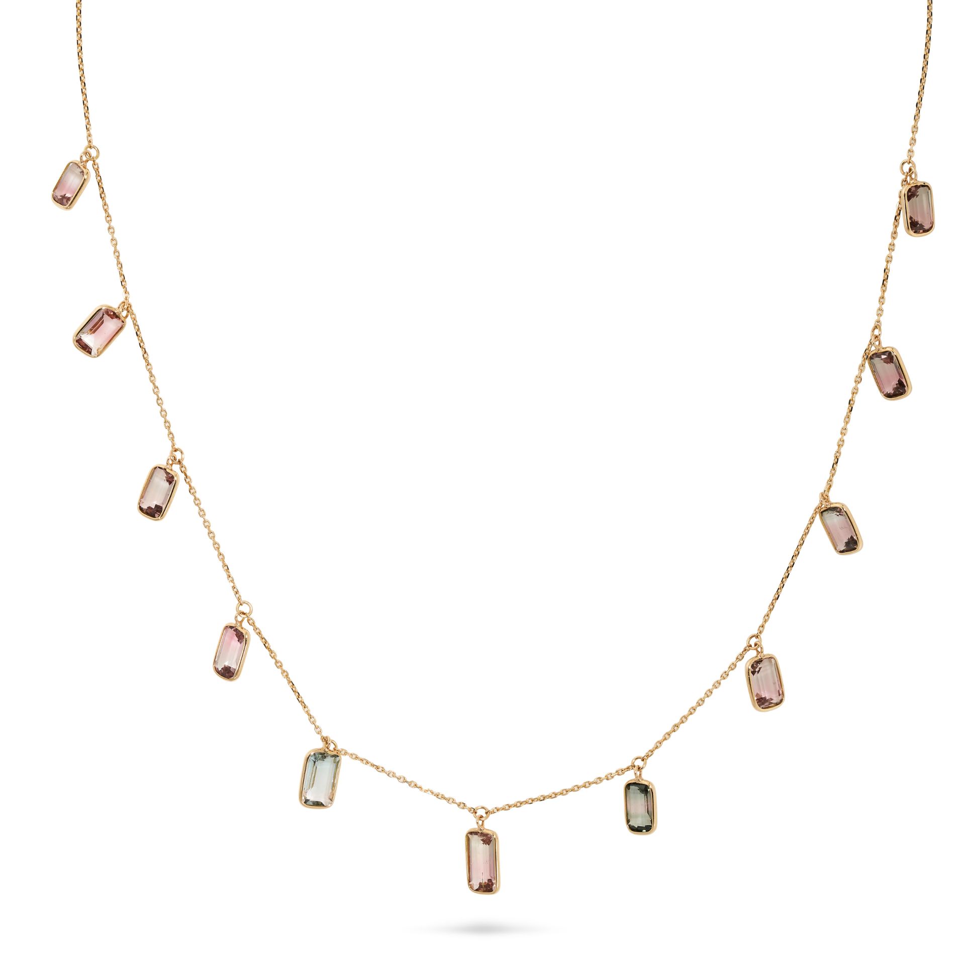 A TOURMALINE FRINGE NECKLACE in 18ct yellow gold, comprising a trace chain suspending a fringe of...