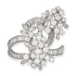 A DIAMOND CLIP BROOCH in 18ct white gold, the scrolling brooch set throughout with round brillian...