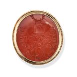 A CARNELIAN INTAGLIO RING in yellow gold, set with a carnelian intaglio carved to depict a family...