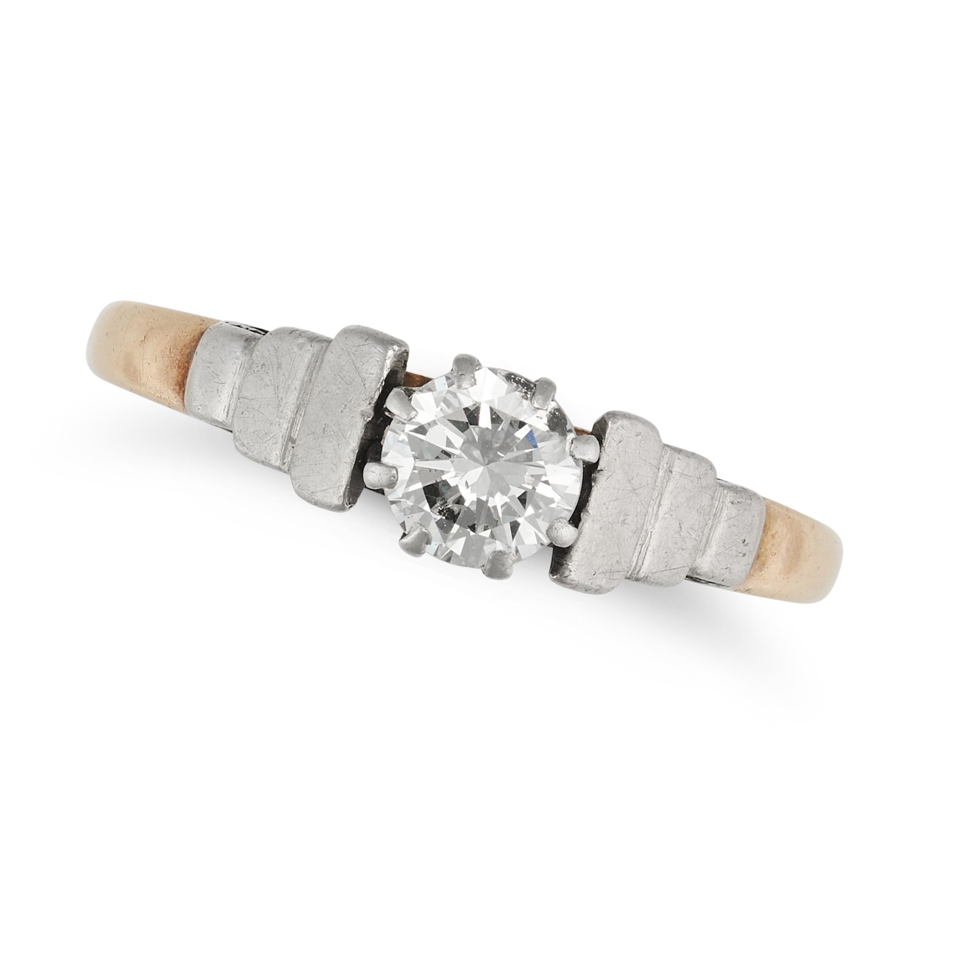A SOLITAIRE DIAMOND RING in 18ct yellow gold and platinum, set with a round brilliant cut diamond...