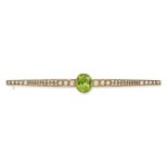 AN ANTIQUE PERIDOT AND PEARL BAR BROOCH in yellow gold, set to the centre with an oval cut perido...