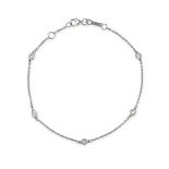 NO RESERVE - A DIAMOND BRACELET in 18ct white gold, comprising a trace chain set with round brill...