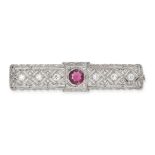 AN ANTIQUE ART DECO RUBY AND DIAMOND BROOCH in white gold, the openwork brooch set with a round c...