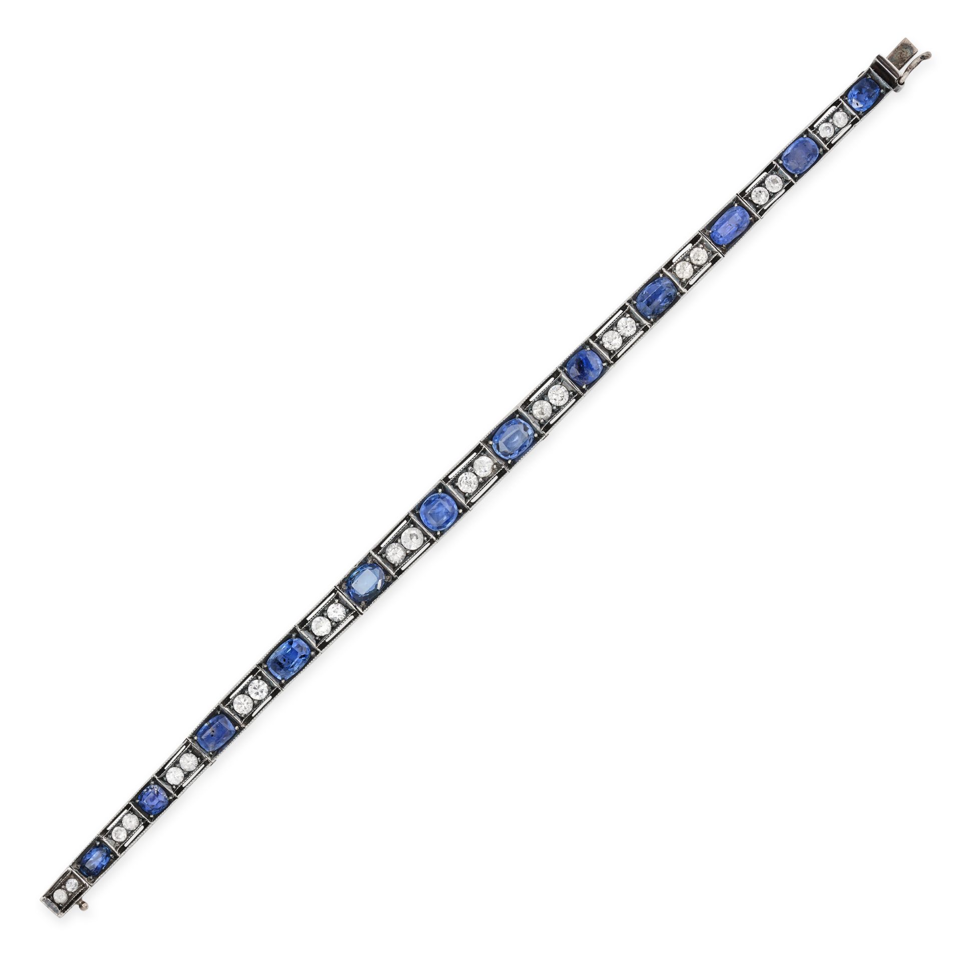 AN ANTIQUE BLUE AND WHITE SAPPHIRE BRACELET in silver, comprising a row of oval cut sapphires acc...