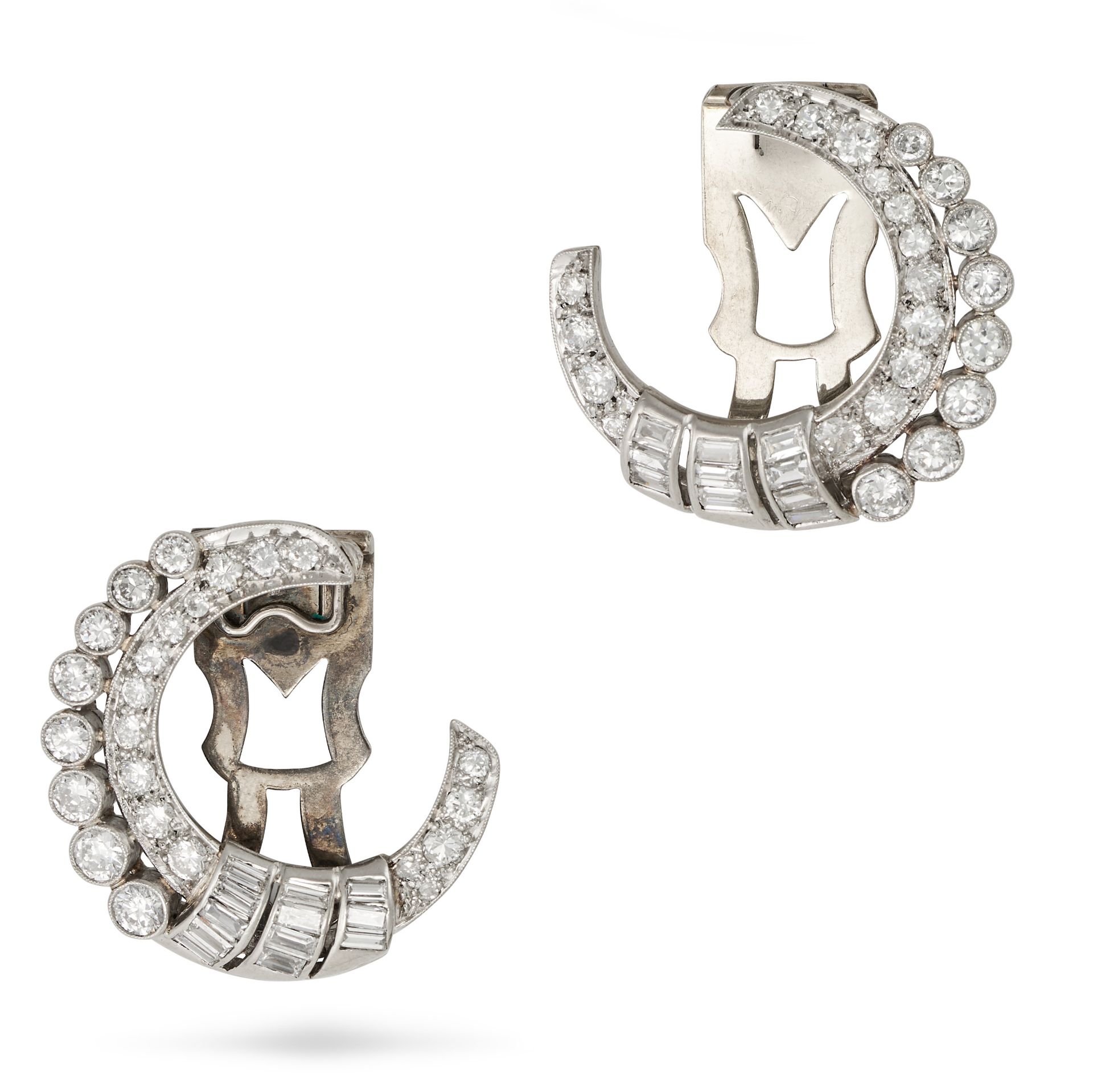 A PAIR OF VINTAGE DIAMOND CRESCENT MOON CLIP BROOCHES in white gold, each designed as a stylised ...