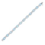 A BLUE TOPAZ AND DIAMOND BRACELET in 18ct white gold, set with a row of oval cut blue topaz inter...