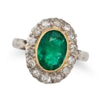 AN EMERALD AND DIAMOND CLUSTER RING in 18ct white and yellow gold, set with an oval cut emerald i...