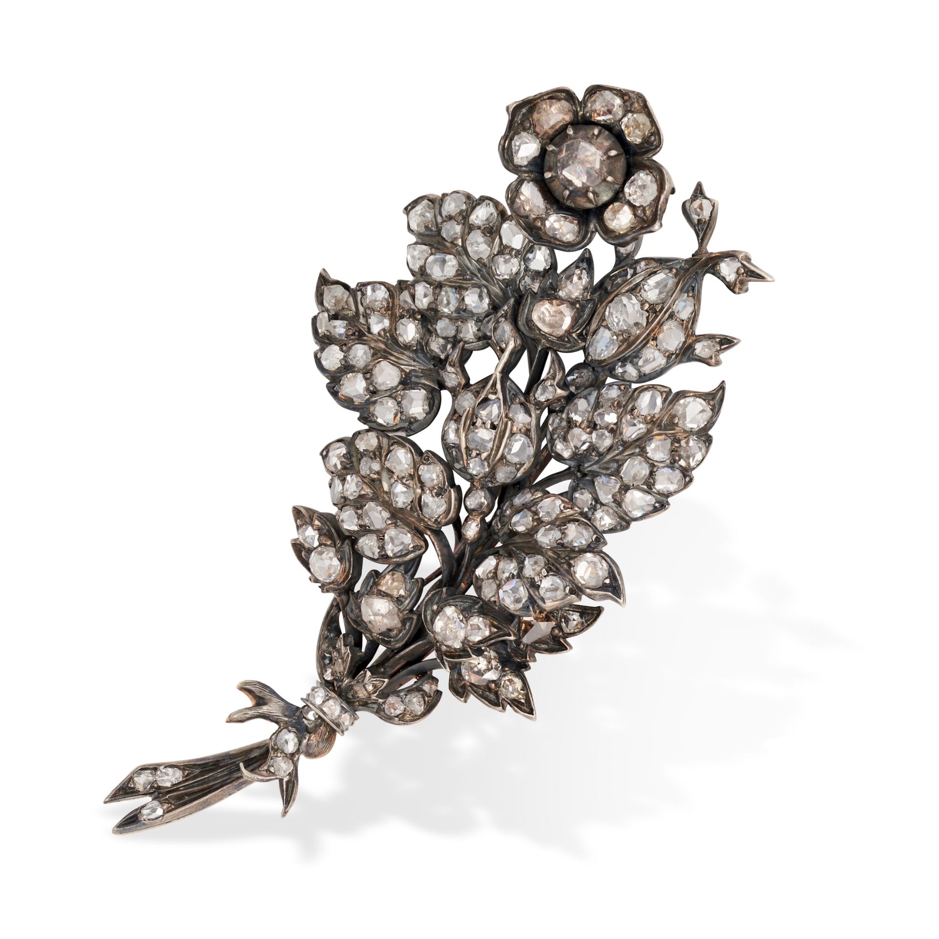 AN ANTIQUE DIAMOND EN TREMBLANT FLORAL SPRAY BROOCH in yellow gold and silver, designed as a flor...