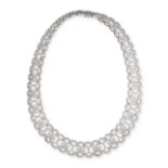 A DIAMOND NECKLACE in 18ct white gold, designed as a row of bows accented by scrolling links, set...